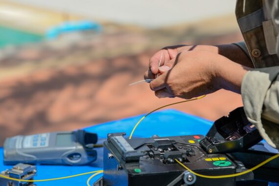 Technicians are cutting and fusion fiber optic cables.
