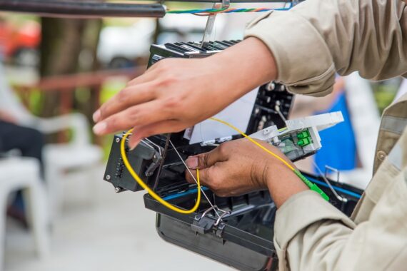 Technicians are install cabinet on fiber optic cable.Blur images